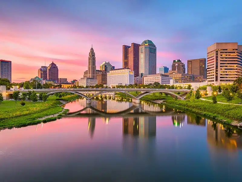 View of a river running through a city at sunset