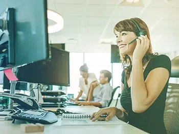 Woman Vacation Rental Insurance Agent Working At Her Desk